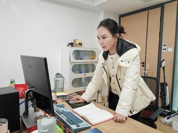Yang Hanhan processes an AI-generated short film at her studio in Wuhan, central China's Hubei province, March 12, 2026. (Xinhua/Yue Wenwan)